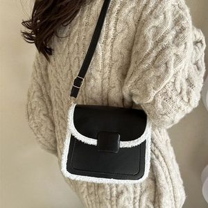 Contrast crossbody square bag with black leather and white faux fur trim on shoulder