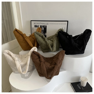 Detailed display of five colors of quilted tote bags with stylish knot handle design