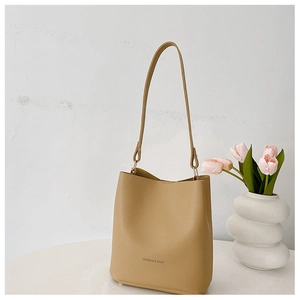 Detail of khaki pebbled leather bucket bag with Fashion & Bags text on white background