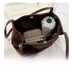 Interior view showing the large capacity of a red and green plaid tweed tote bag