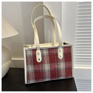Red and grey plaid woolen tote bag with white leather trim and gold rivet details