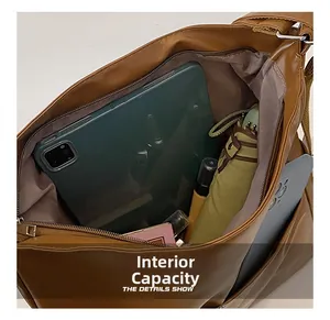 Internal view of large capacity tote bag holding a tablet, umbrella and phone