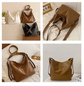 Detail view of large hobo tote bags in white, brown, and black soft faux leather material