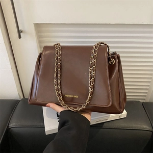 Large dark brown vintage leather tote bag with gold chain strap and front logo print