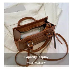 Capacity display of vintage brown crossbody bag showing interior lining and wallet space