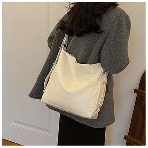 Detail of minimalist cream white leather tote bag showing large capacity and soft texture