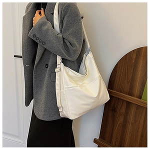 Minimalist white leather hobo bag with adjustable strap and side pocket detail