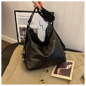 Detail of black large capacity hobo bag with adjustable nylon strap and side pocket
