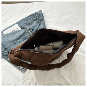 Detailed top view of brown quilted bag showing large capacity for umbrella and wallet