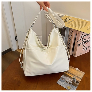 Detail of a large white vintage tote bag made of soft PU leather with front pocket
