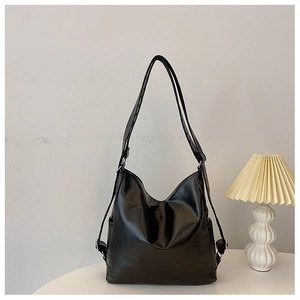 Detail view of the black minimalist PU leather crescent bag with adjustable straps
