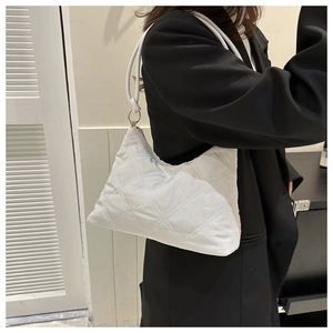 Close-up of a quilted light grey crescent shoulder bag with elegant rhombus stitching
