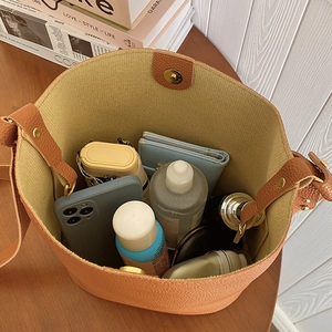 Large vintage brown lychee grain bucket bag showing spacious interior with daily essentials