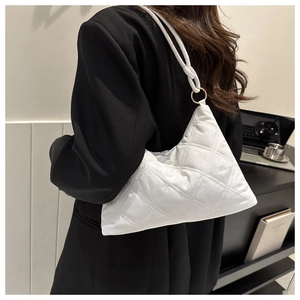Detail of white quilted down shoulder bag with metal ring and asymmetric design