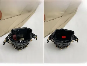 Detail view of mini quilted bucket bag capacity for phone and cosmetics with gold chains