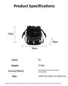Close-up of black quilted mini bucket bag with gold heart charms and chain strap detail