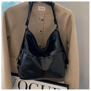 Detail of black large hobo bag featuring soft leather texture and adjustable strap