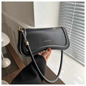 Detail of smooth black leather shoulder bag featuring gold chain and logo branding