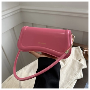 Detail of pink shoulder bag showing XM & BAGS logo and smooth leather texture