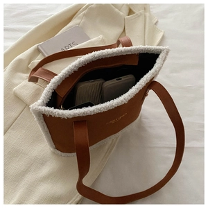 Close-up of brown suede tote bag interior showing large capacity for phone and wallet