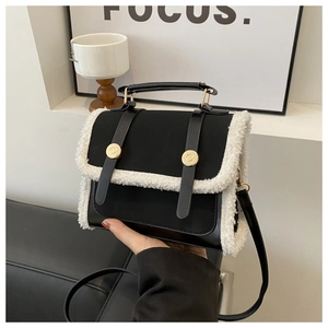 Close-up of contrast crossbody bag with black leather and white shearling details
