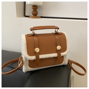 Detail of vintage crossbody bag featuring brown faux leather and white shearling trim accents