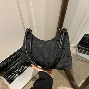 Quilted black nylon shoulder bag with elegant gold hardware and rhombus stitch pattern