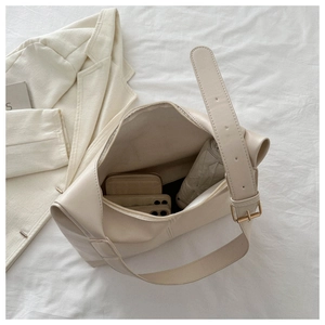 Interior view of large beige leather tote bag showing space for phone and umbrella