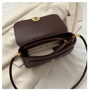 Internal view of dark brown leather handbag showing large storage capacity and pockets