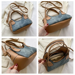Detail view of denim and brown leather patchwork shoulder bag with interior storage