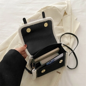Chic black fabric crossbody bag with creamy faux fur trim and gold magnetic buckle