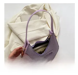 Detailed view of the purple woven crescent bag capacity with its internal storage space