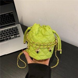 Quilted lime green bucket bag with heart charms and gold chain straps