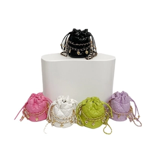 Quilted mini bucket bag with chain strap and heart pendant in five vibrant candy colors