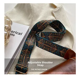Detail of adjustable bohemian geometric pattern wide strap on a brown leather bag