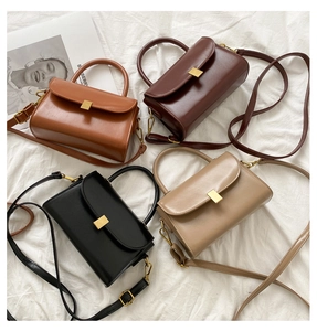 Collection of four vintage leather crossbody bags in tan, brown, black, and beige with gold buckles