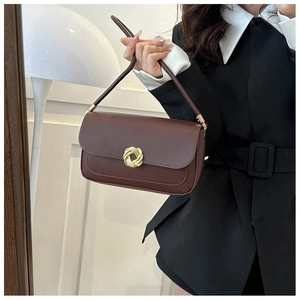 Minimalist dark brown baguette shoulder bag with a gold metal twist ring buckle detail