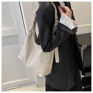 Side view of cream large capacity tote bag with wide strap and metallic buckle