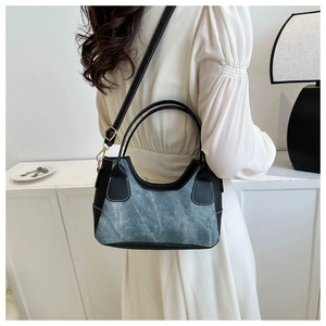 Chic patchwork denim and leather underarm bag with contrast stitching and gold hardware