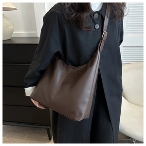 Detail of dark brown matte PU leather hobo shoulder bag with vertical seam stitching