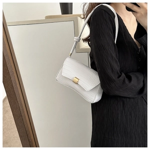 Close-up of white crocodile texture faux leather shoulder bag with gold metal buckle