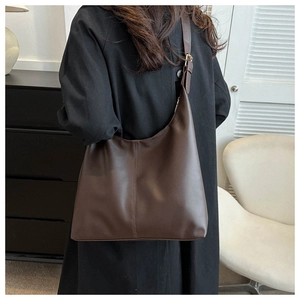 Detail view of large dark coffee Hobo shoulder bag with elegant vertical stitching