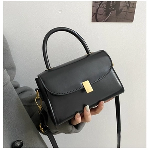 Vintage black faux leather crossbody bag with top handle and gold rectangular buckle