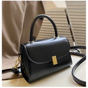 Classic black rectangular shoulder bag with top handle and gold metal buckle
