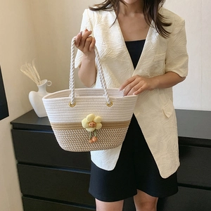 Two-tone woven bucket bag with floral detail for summer casual shoulder styling