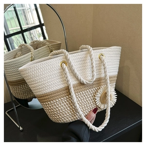 Close-up of woven tote bag with 3D daisy flower and thick cotton rope handles