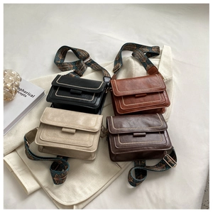 Detailed flat lay of four vintage square crossbody bags with patterned webbing straps