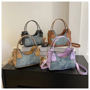 Detail view of stylish color-block crossbody bags in four colors made of PU leather and denim