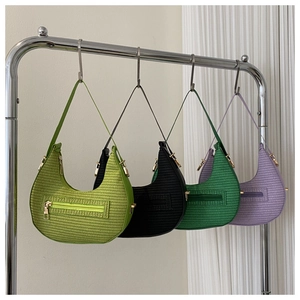 Detail of woven crescent hobo bags in assorted colors with sleek gold zipper accents