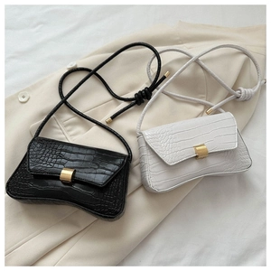 Detail showing crocodile-embossed leather texture and gold metal buckle on shoulder bags